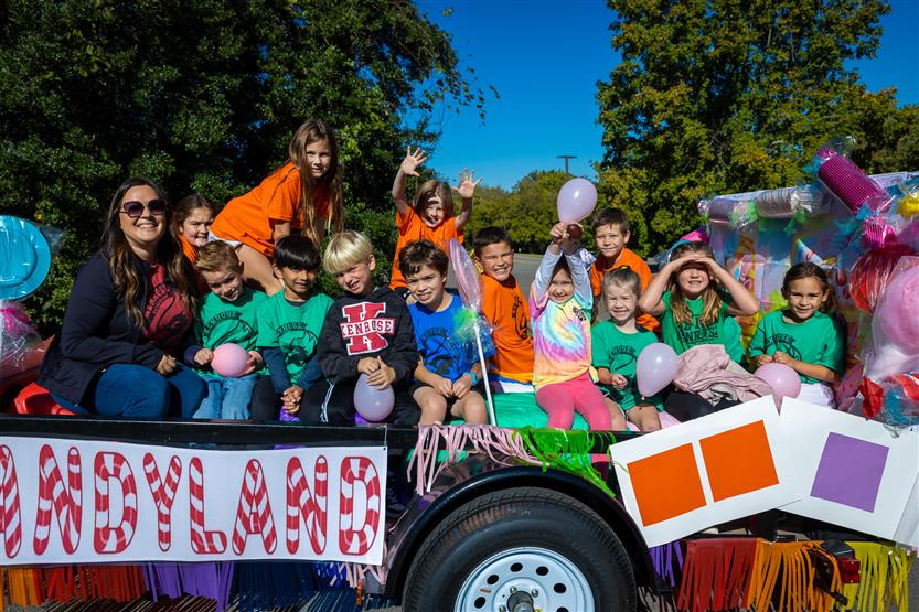 Kenrose Elementary students sit in a trailer of a parade float